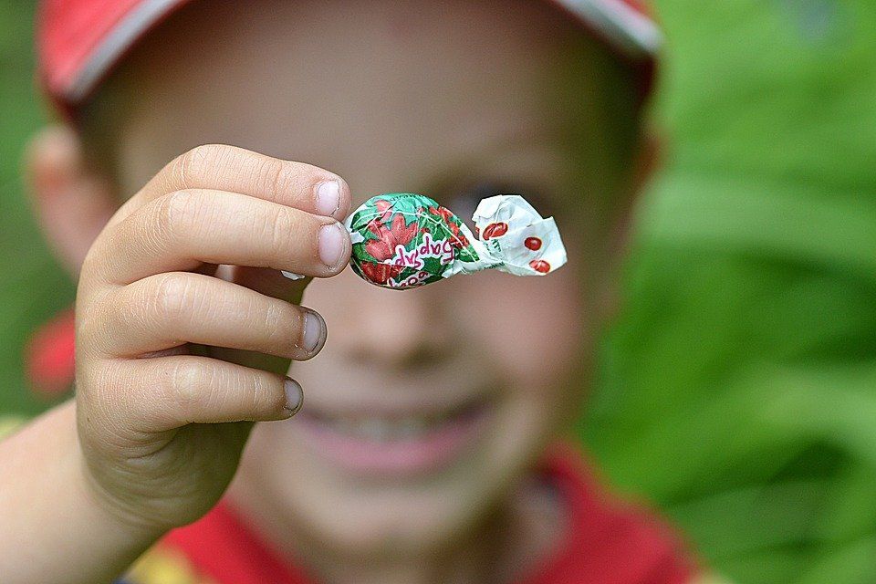 kid holding a piece of candy