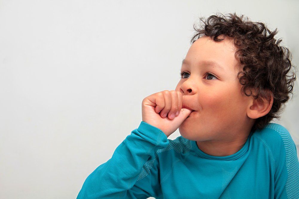 young kid sucking their thumb