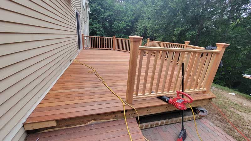 A wooden deck is being built next to a house.