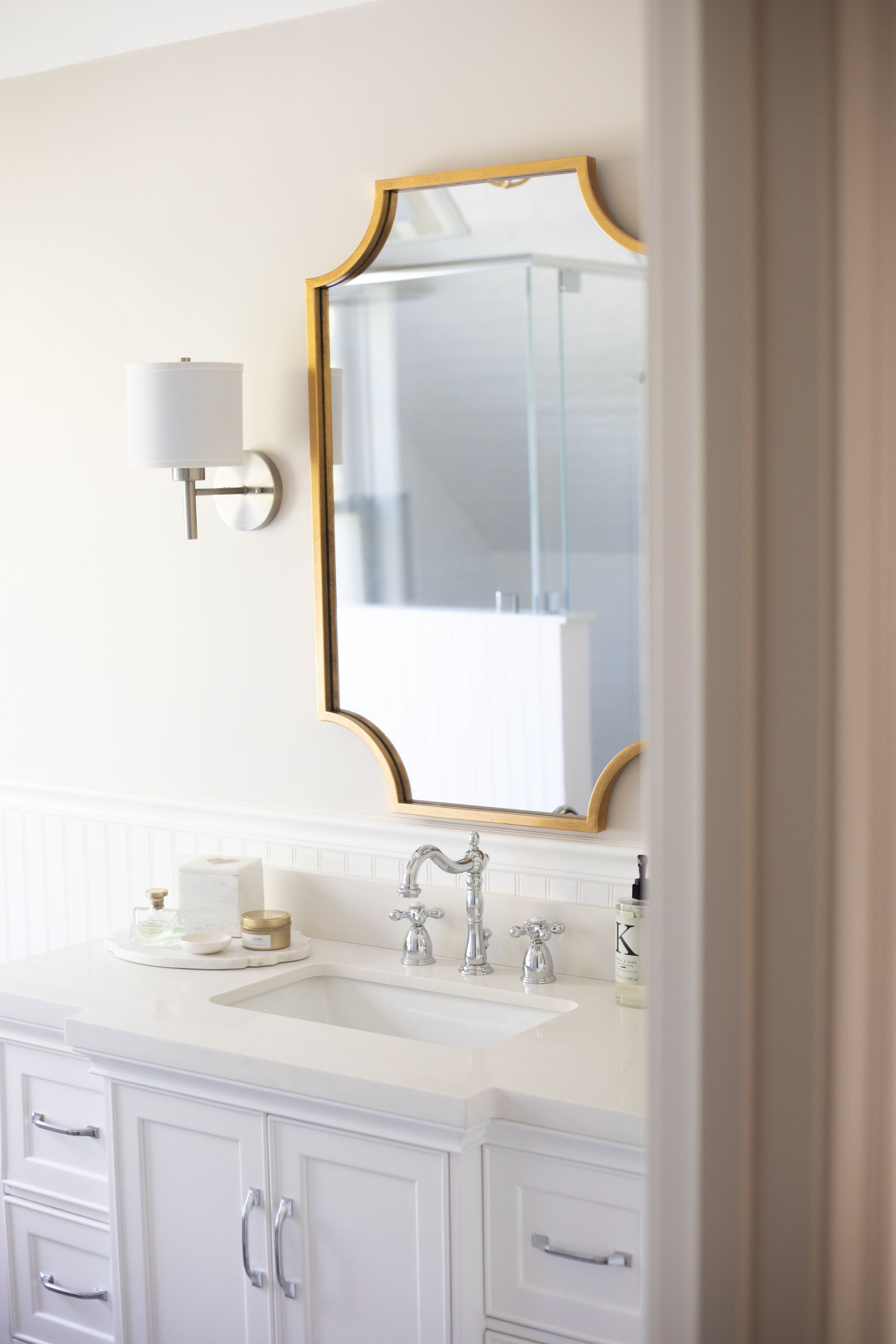A bathroom with a sink and a walk in shower.