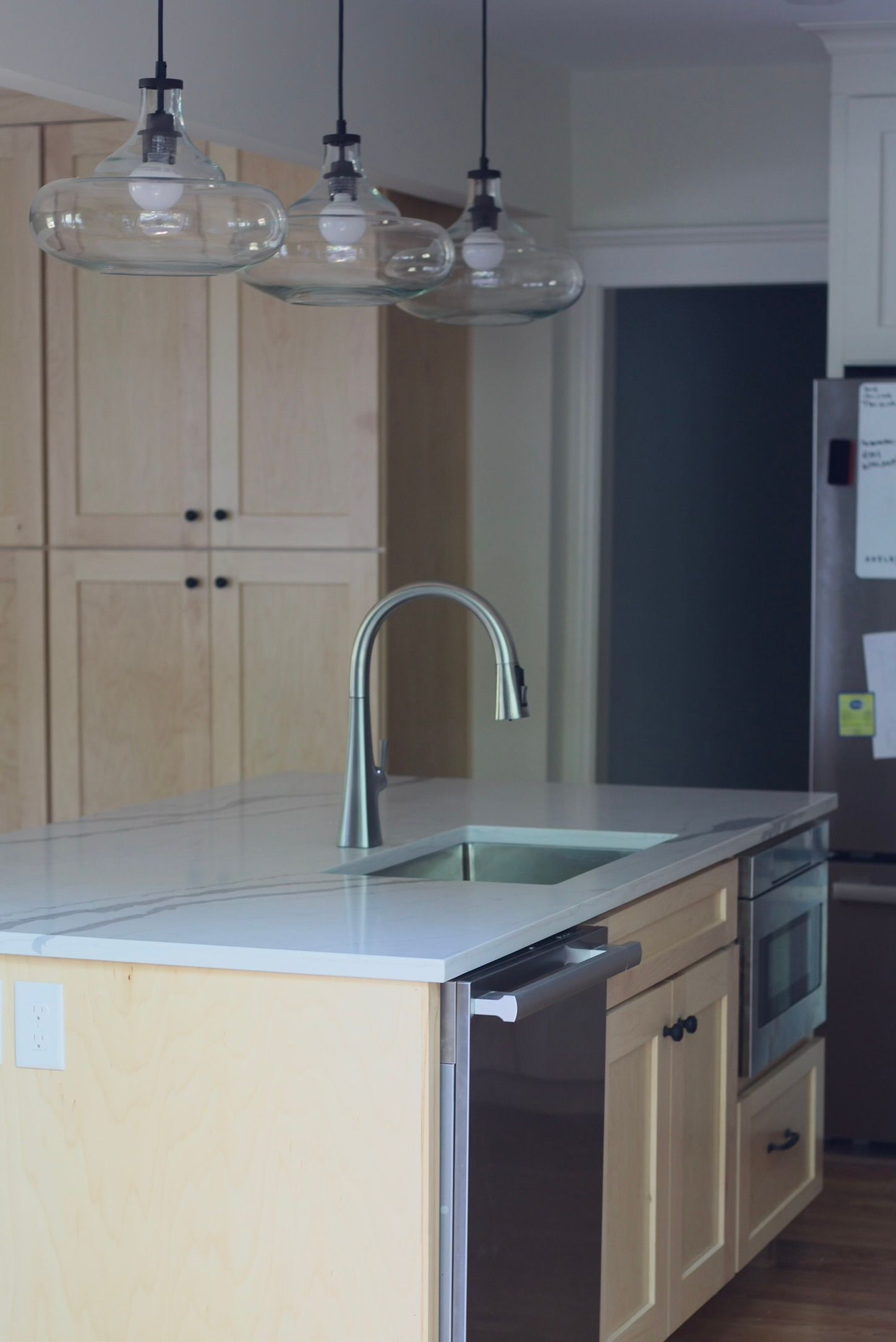 A kitchen with a table and chairs and a refrigerator.