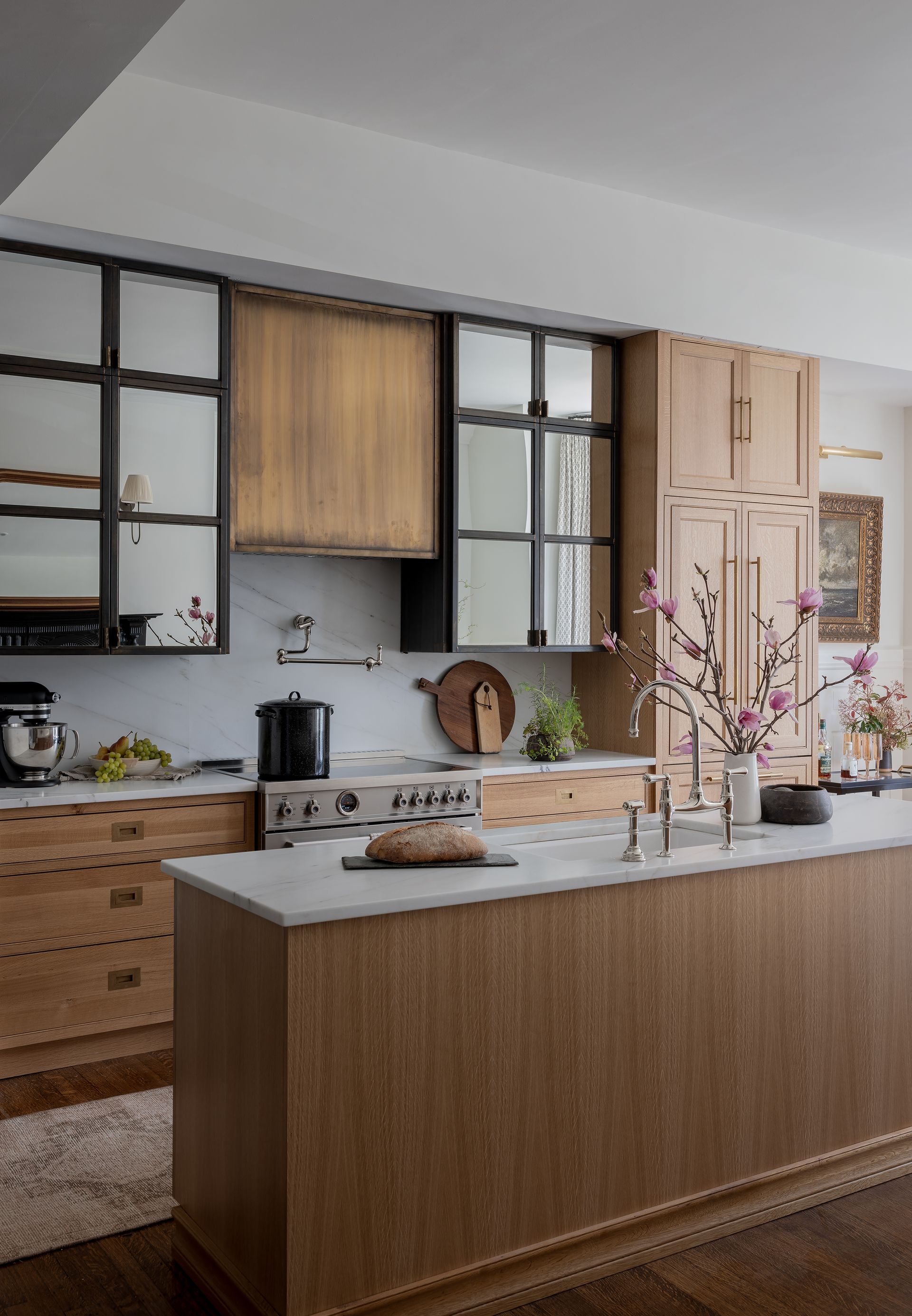A kitchen with white cabinets and a ceiling fan.