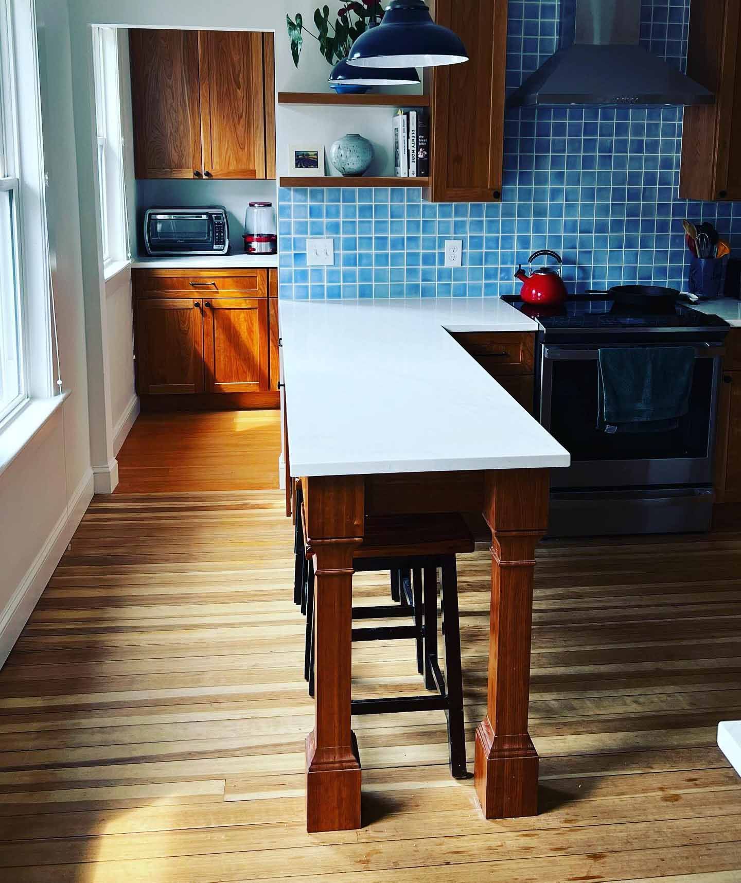 A kitchen with wooden cabinets and a white counter top
