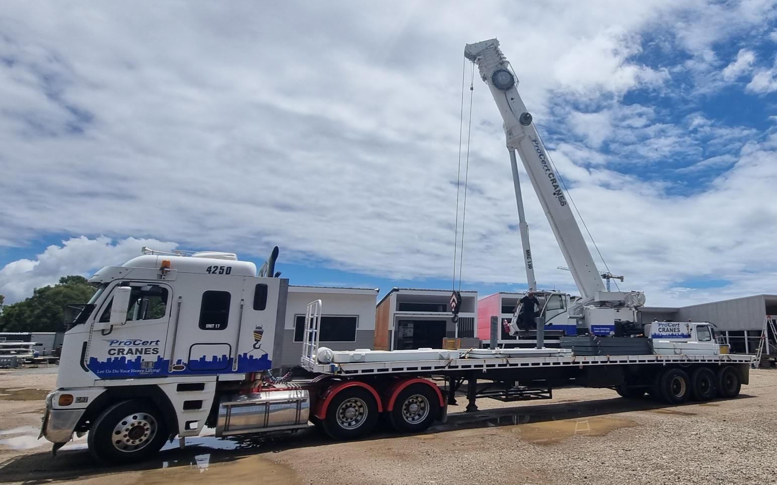 A White Truck With A Crane Attached To It Is Parked In A Gravel Lot — ProCert Cranes In Coolum Beach, QLD