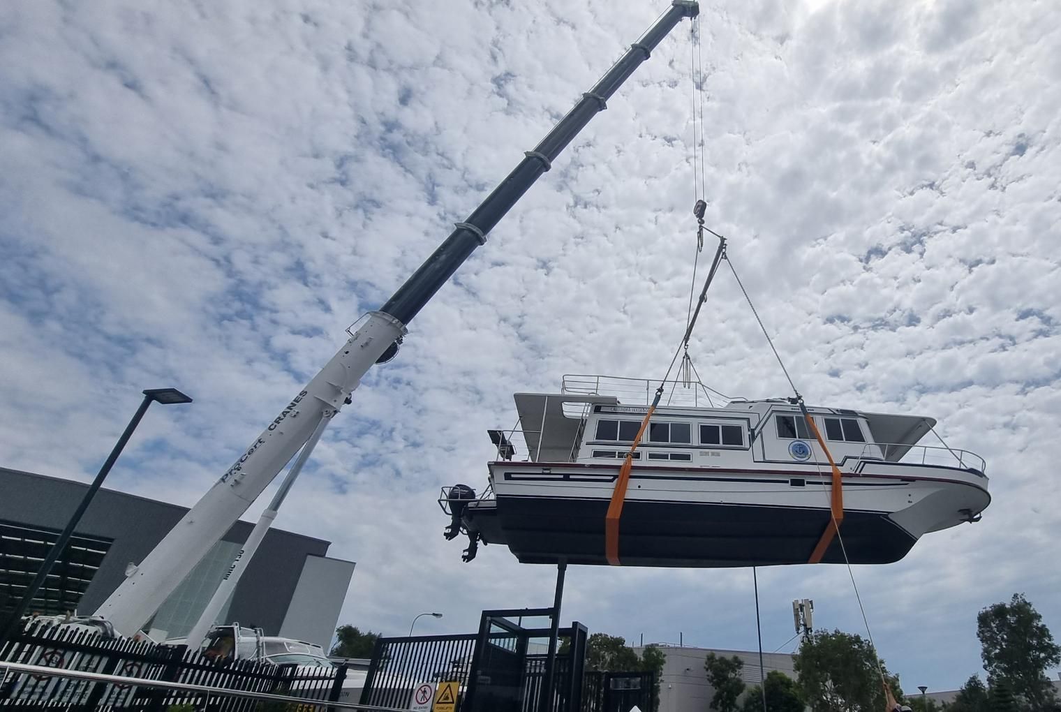 A Boat Lifted Up By Crane— ProCert Cranes In Coolum Beach, QLD