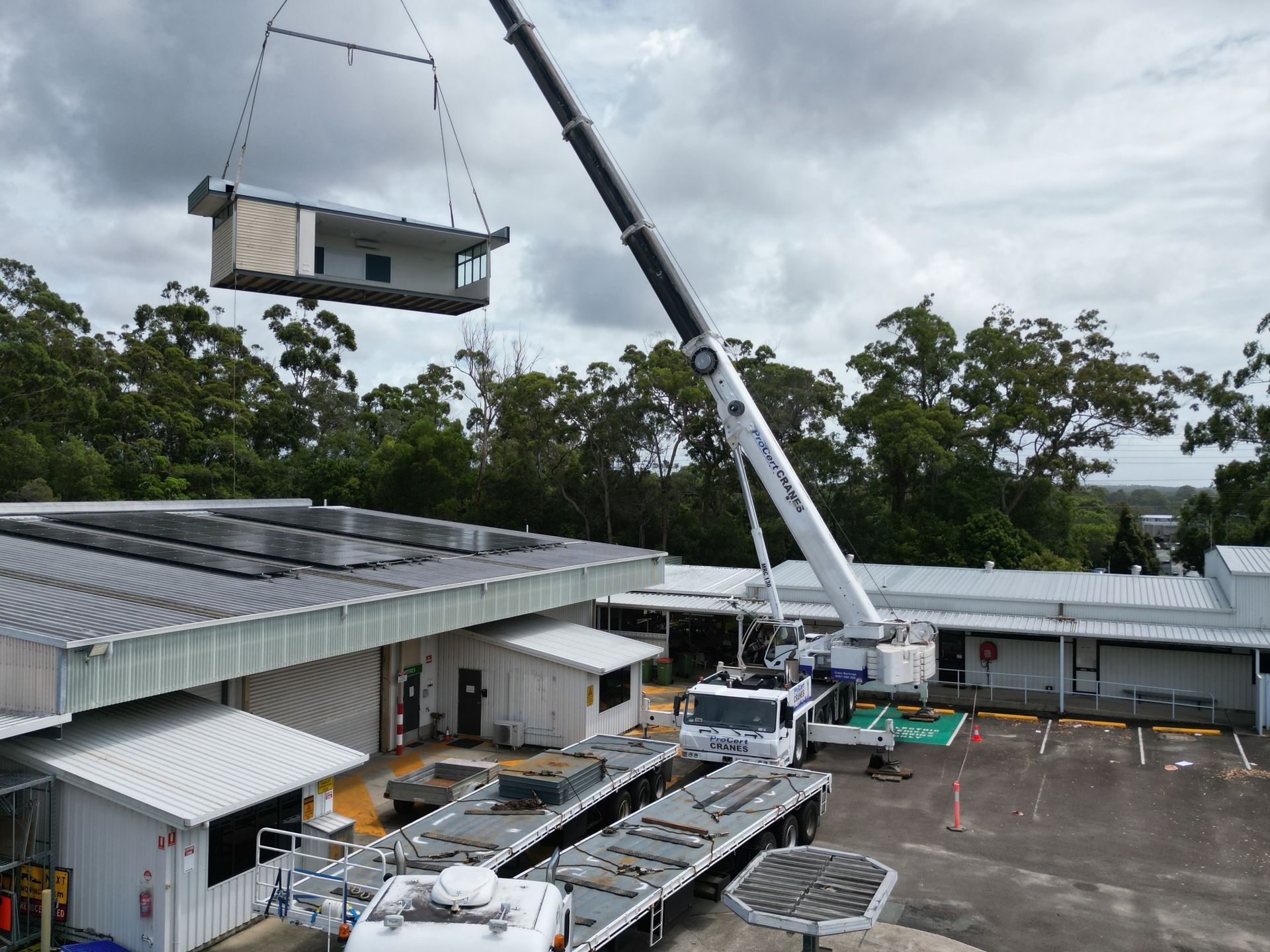 A Crane Is Lifting A Large Container — ProCert Cranes In Coolum Beach, QLD