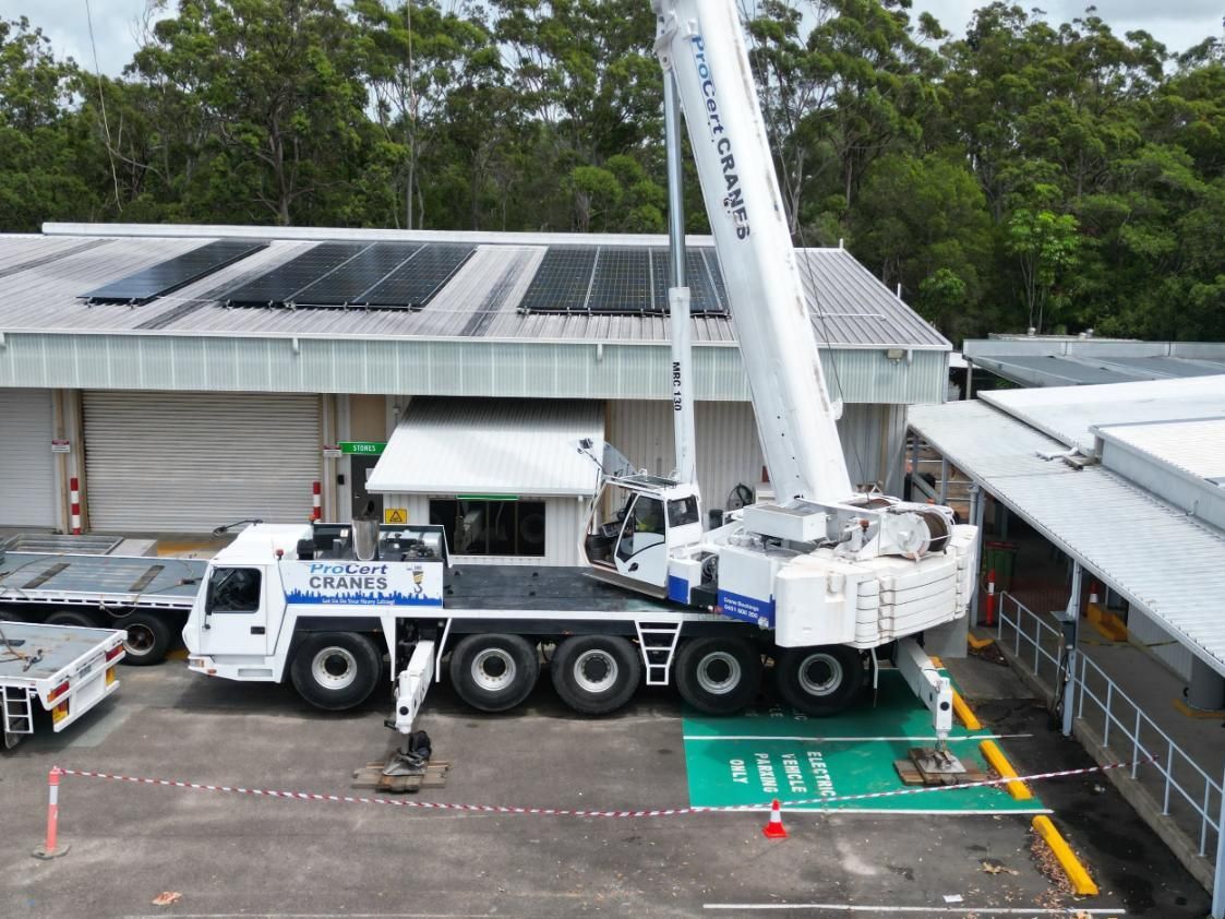 A Large Crane Is Parked In Front Of A Building — ProCert Cranes In Coolum Beach, QLD