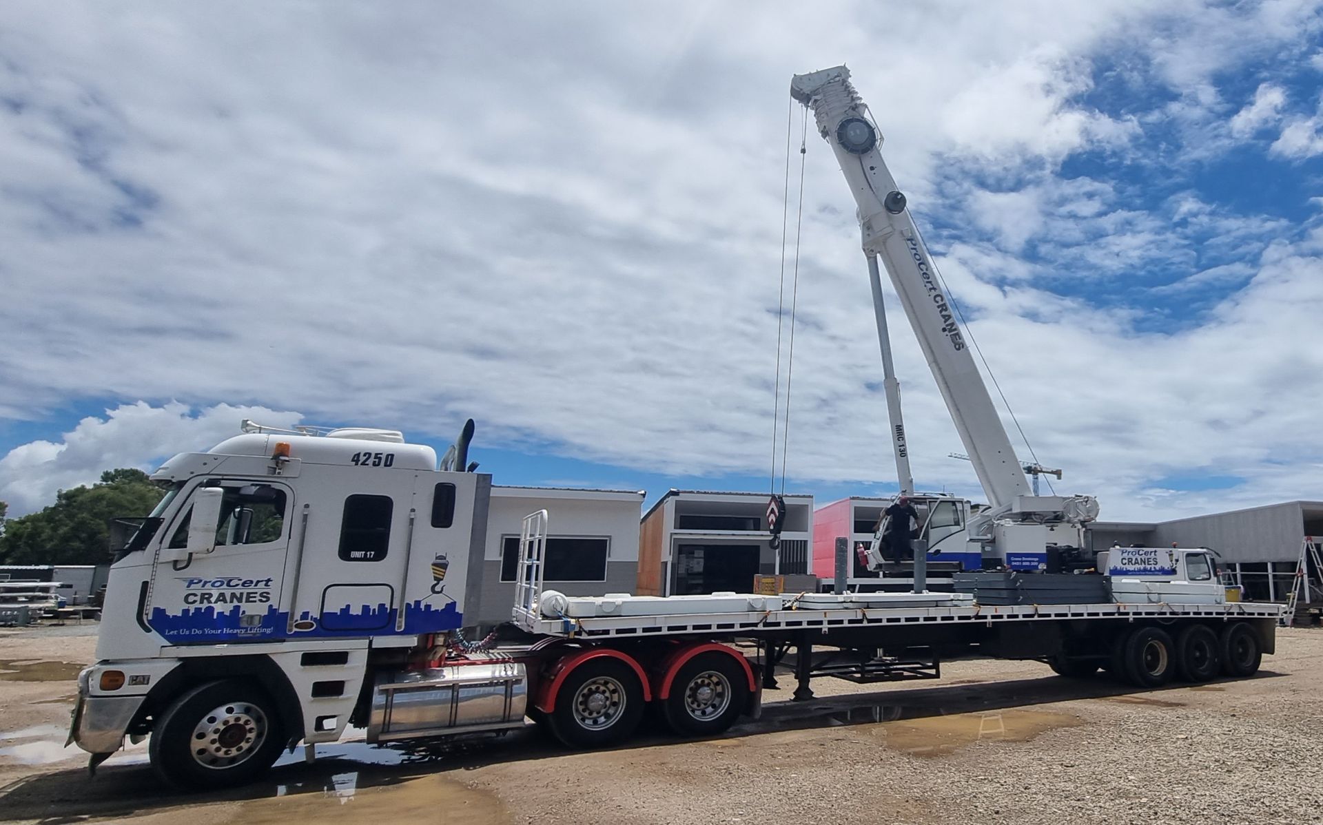 A Large White Crane Is Parked In A Parking Lot — ProCert Cranes In Coolum Beach, QLD