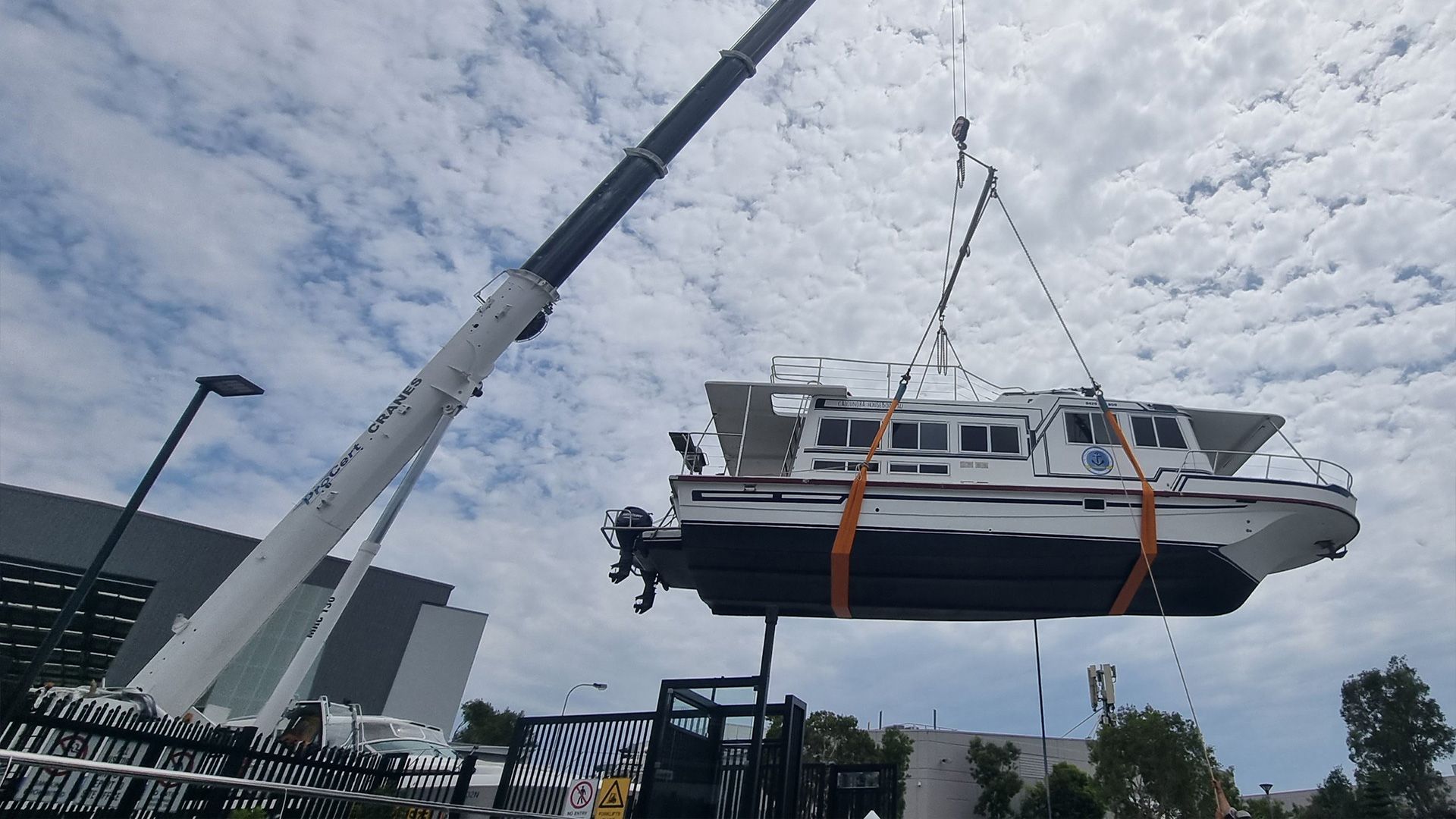 A Crane Is Lifting A Boat — ProCert Cranes In Caloundra, QLD