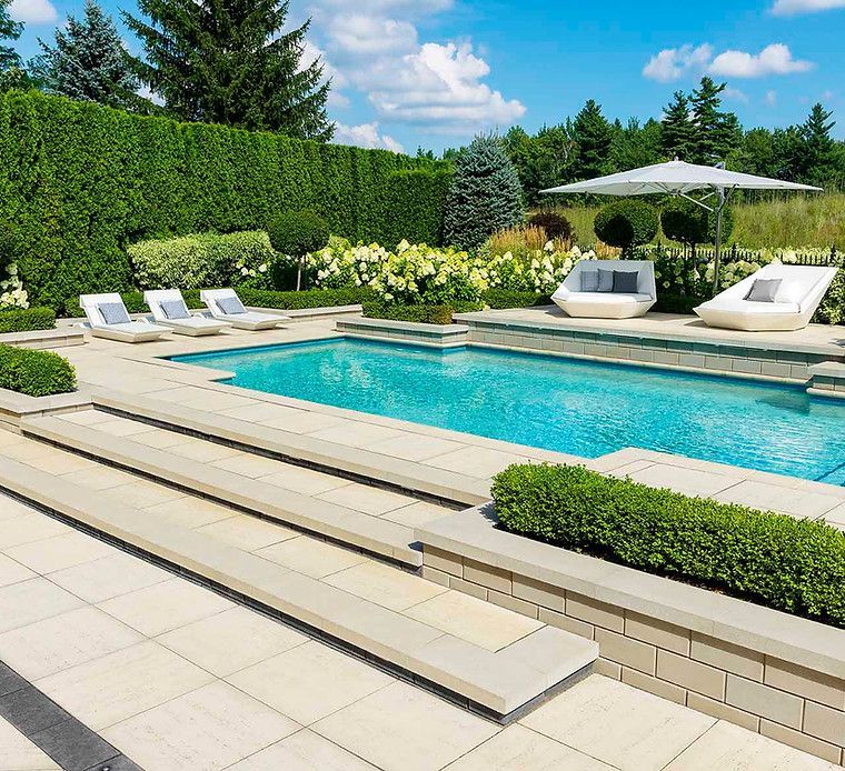 A large swimming pool surrounded by chairs and umbrellas