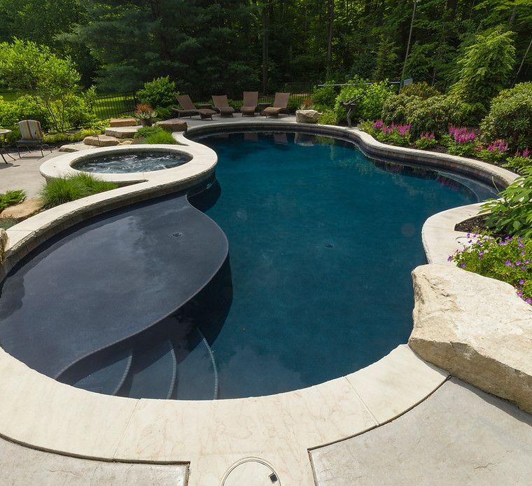 A large swimming pool with stairs leading to it