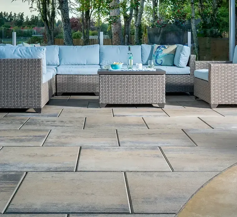 A patio with wicker furniture and a coffee table