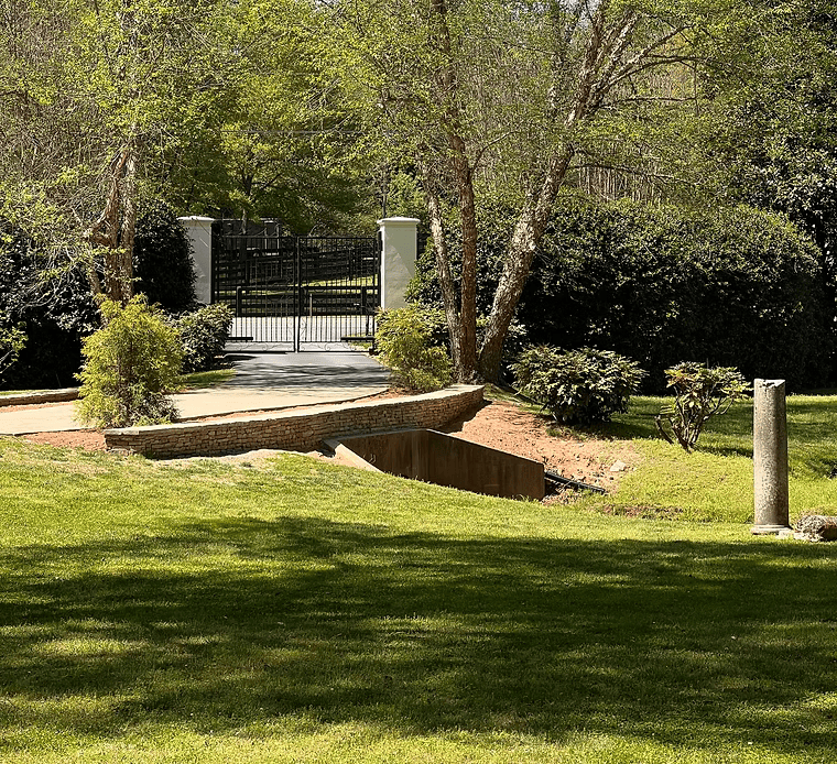 A lush green park with a gate in the background