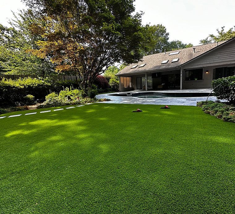 A house with a large lawn in front of it