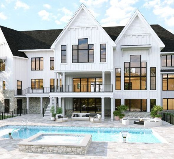 A large white house with a swimming pool in front of it