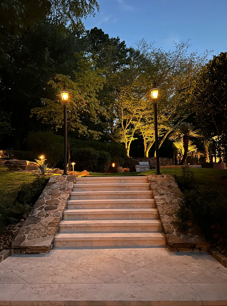 A set of stairs leading up to a park at night.