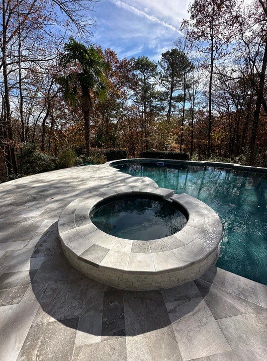 There is a hot tub in the middle of the pool.