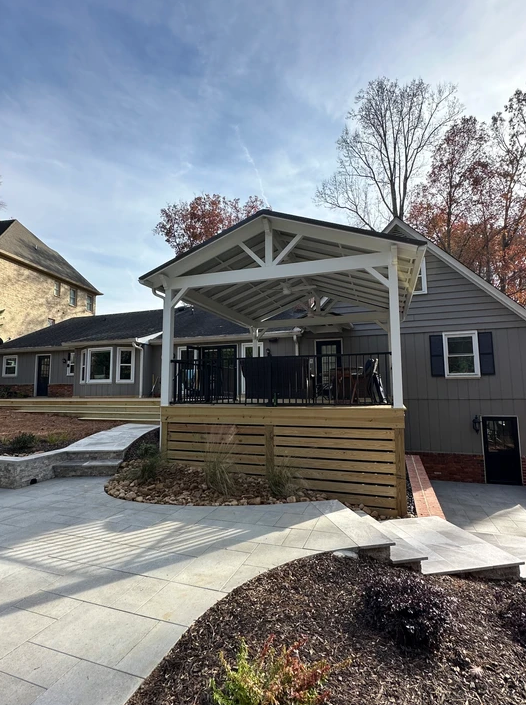 A house with a large porch and a ramp in front of it.