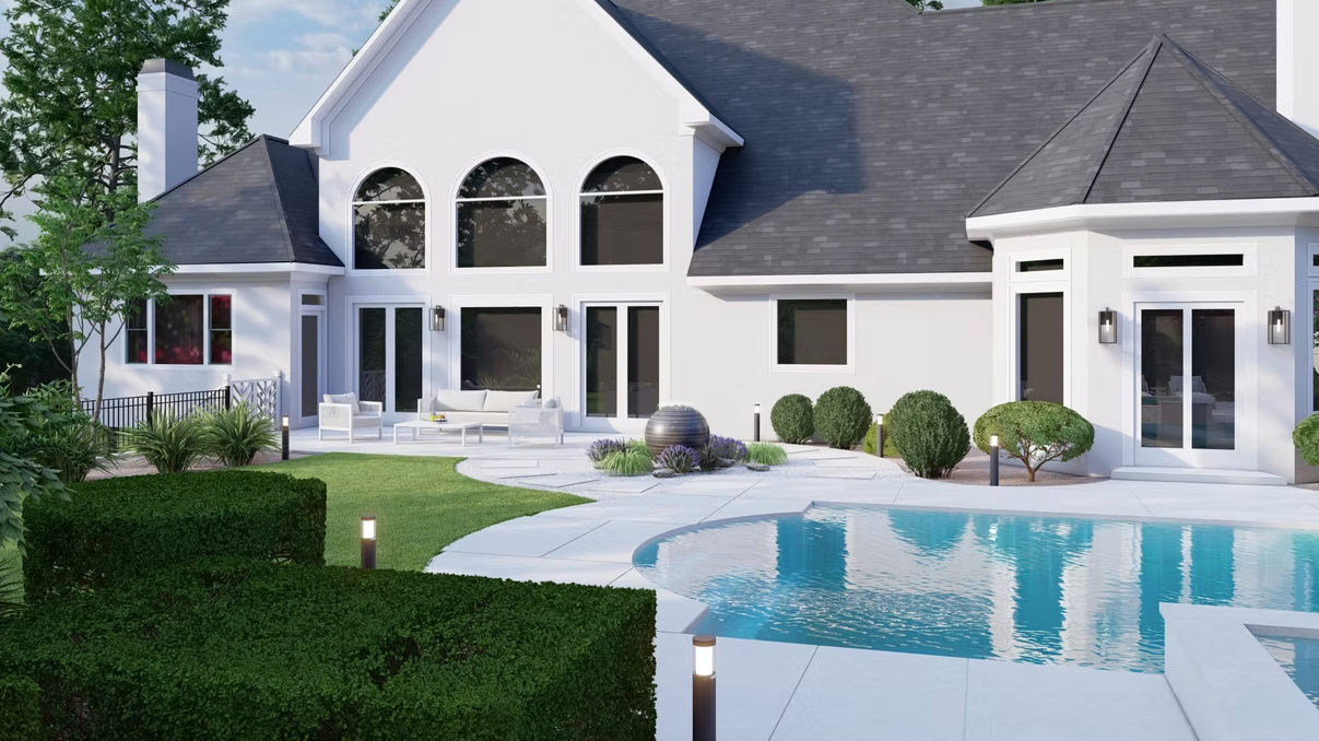 A large white house with a swimming pool in front of it.