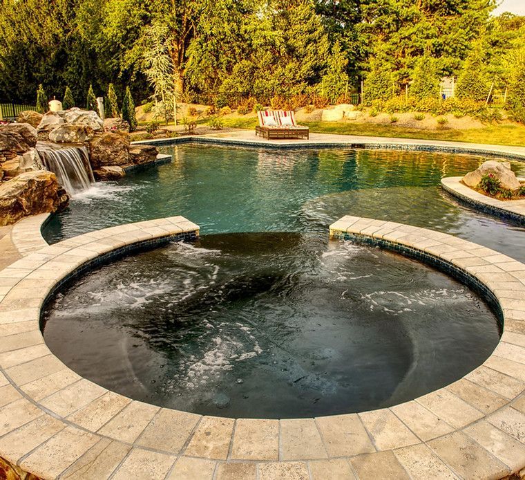 A large swimming pool with a waterfall in the background