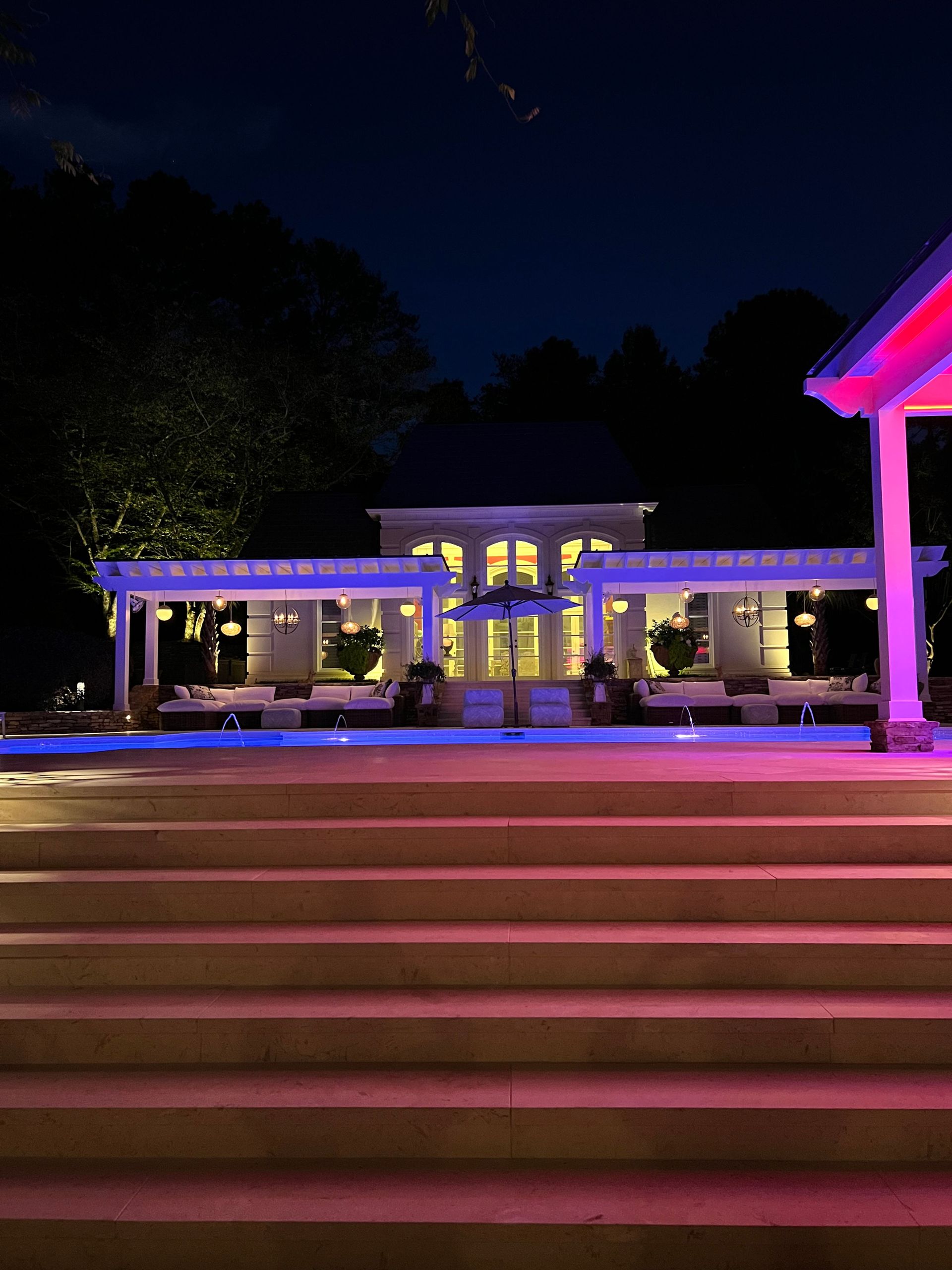 A house is lit up with purple lights at night