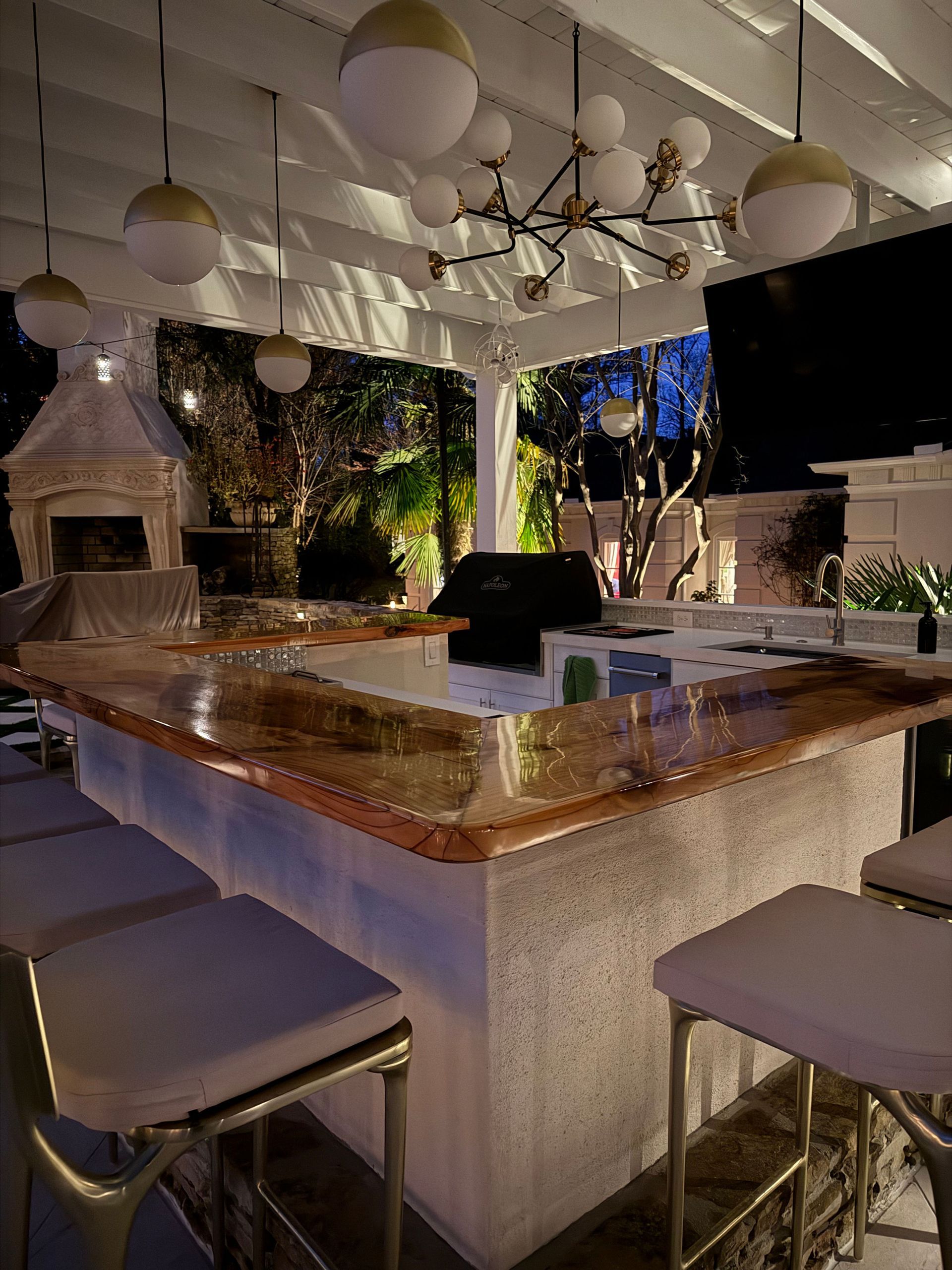 A kitchen with a marble counter top and stools
