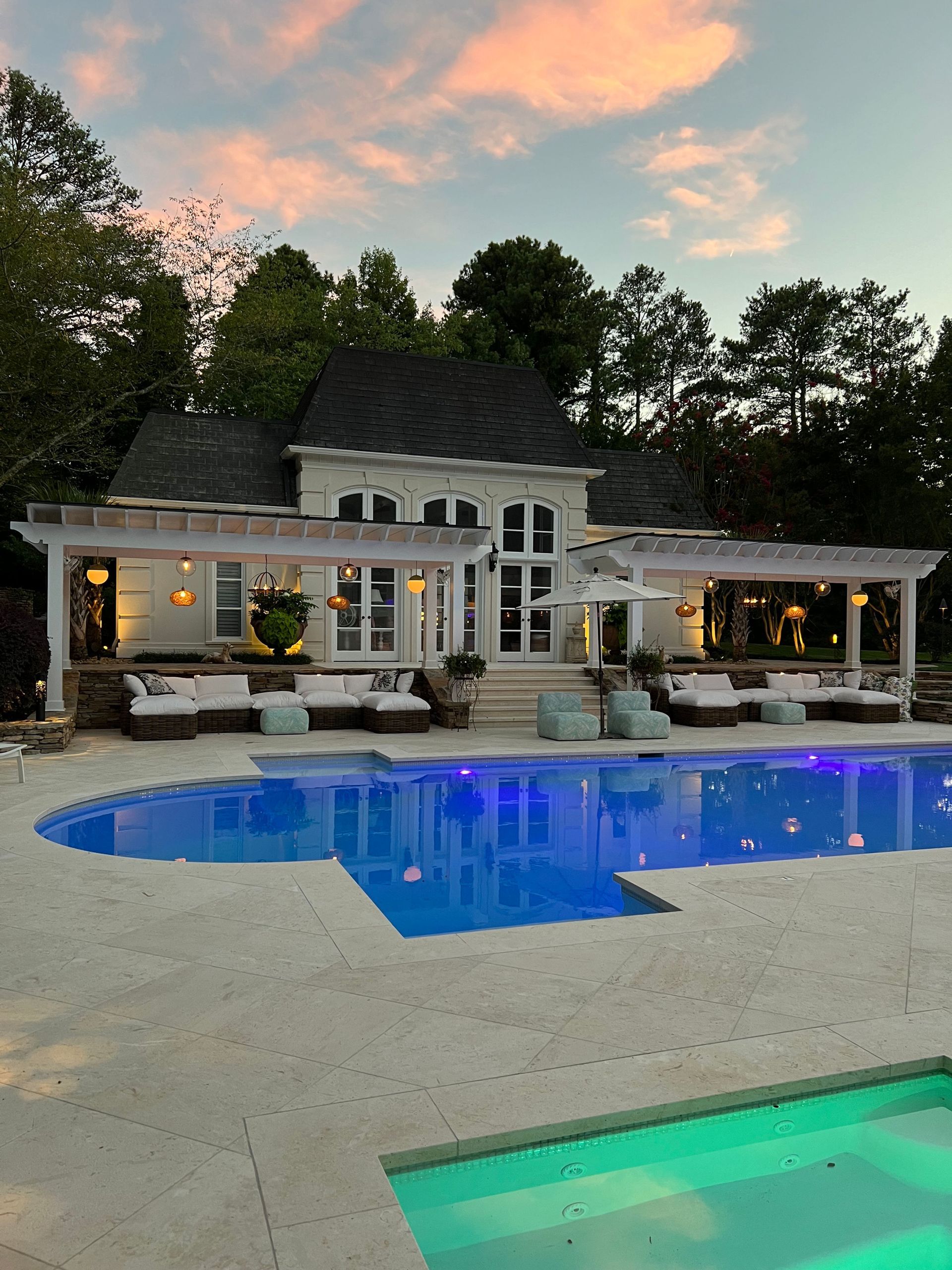 A large house with a large swimming pool in front of it