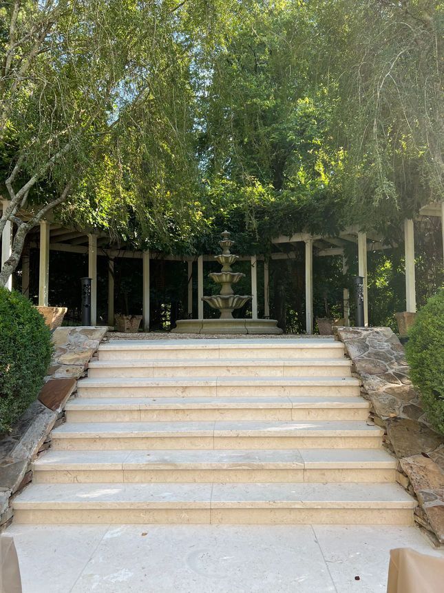 There is a fountain in the middle of the stairs.