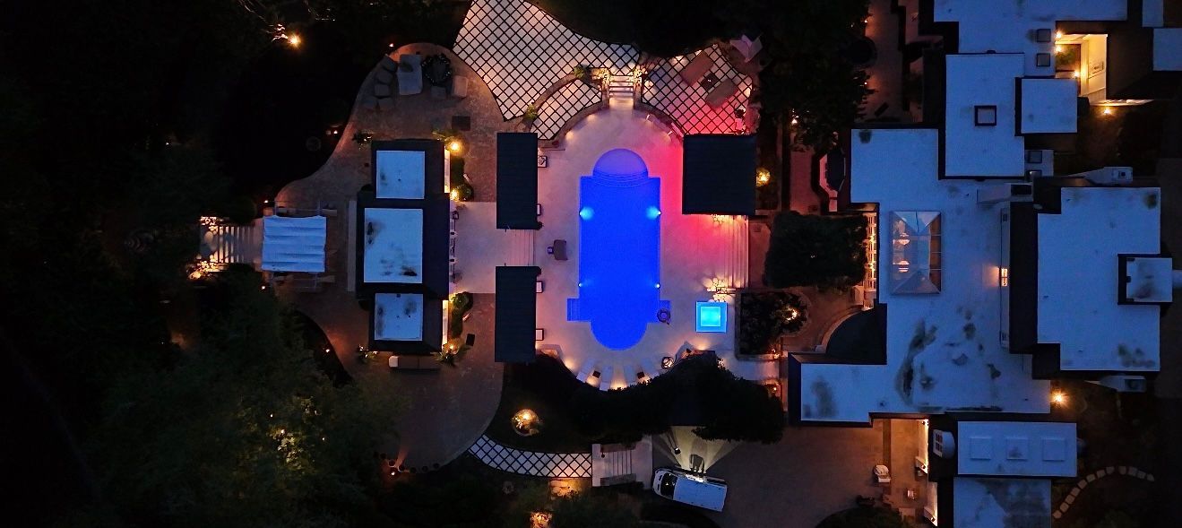 An aerial view of a large swimming pool at night.