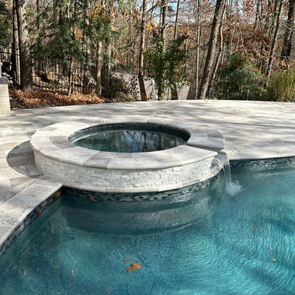 There is a hot tub in the middle of the pool.