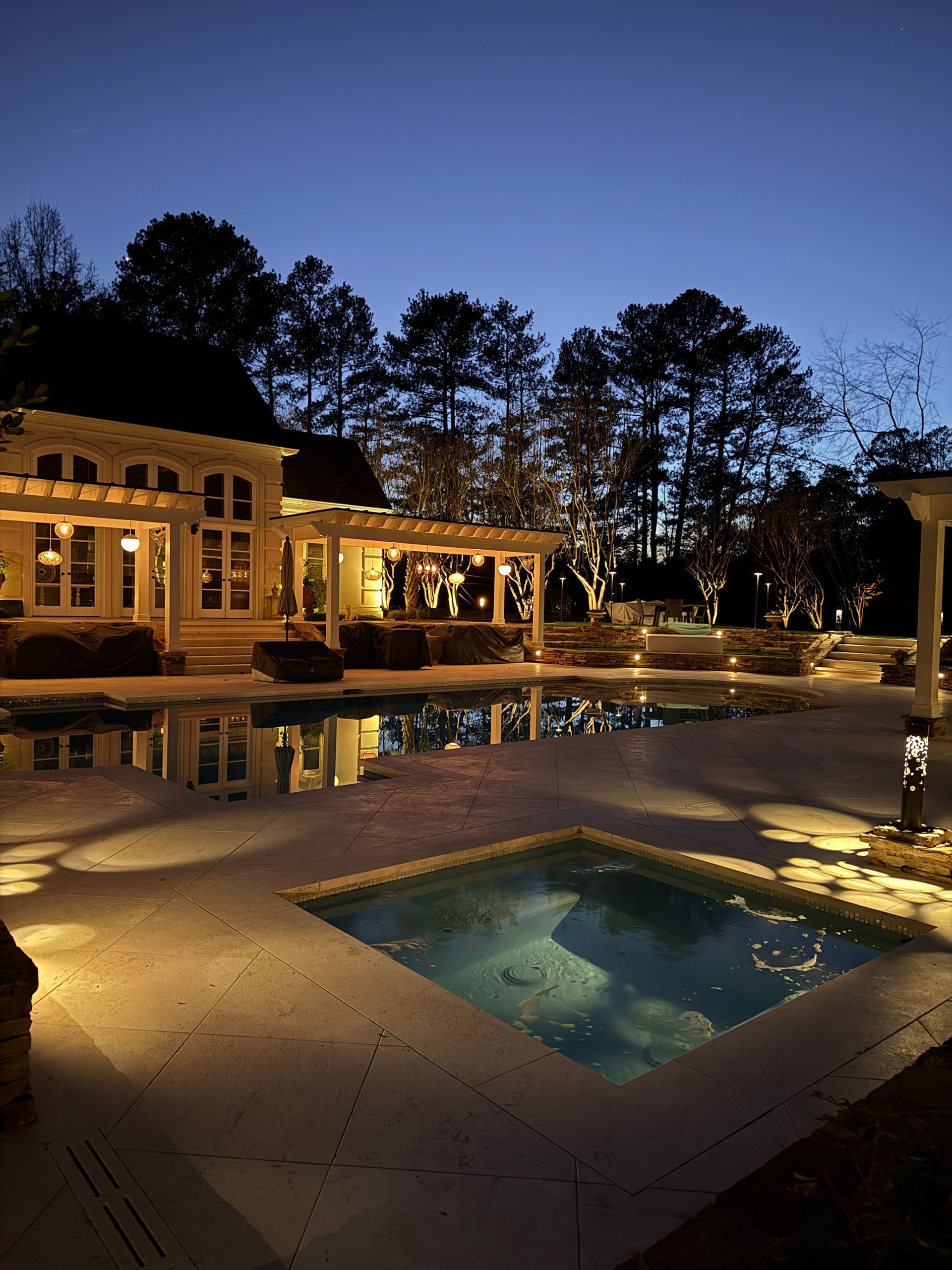 A large house with a swimming pool in front of it