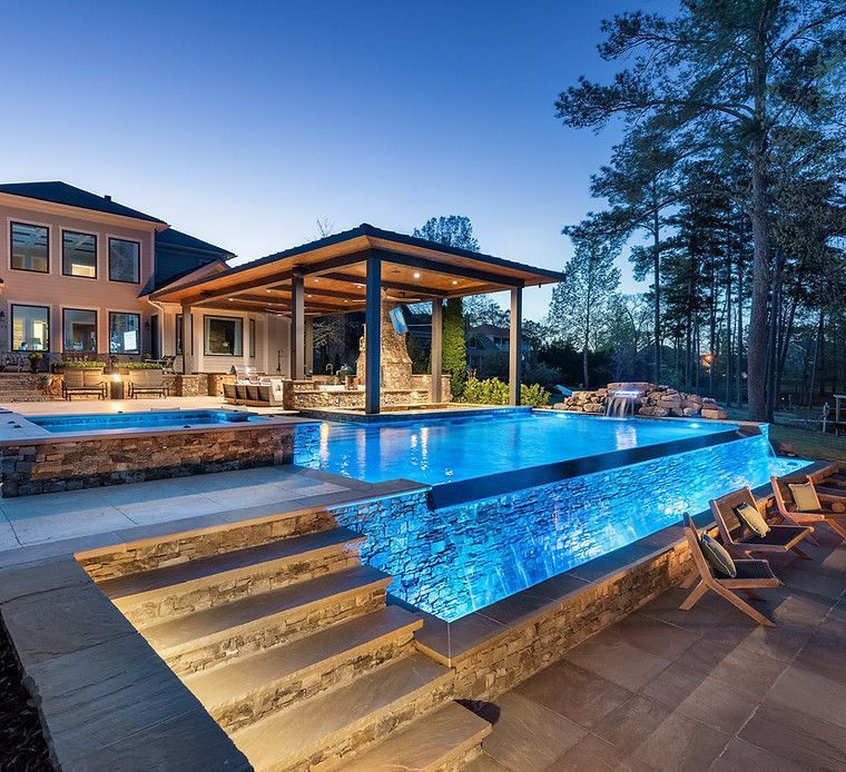 A large house with a swimming pool in front of it