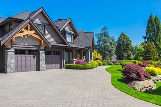 A large house with a large driveway in front of it.