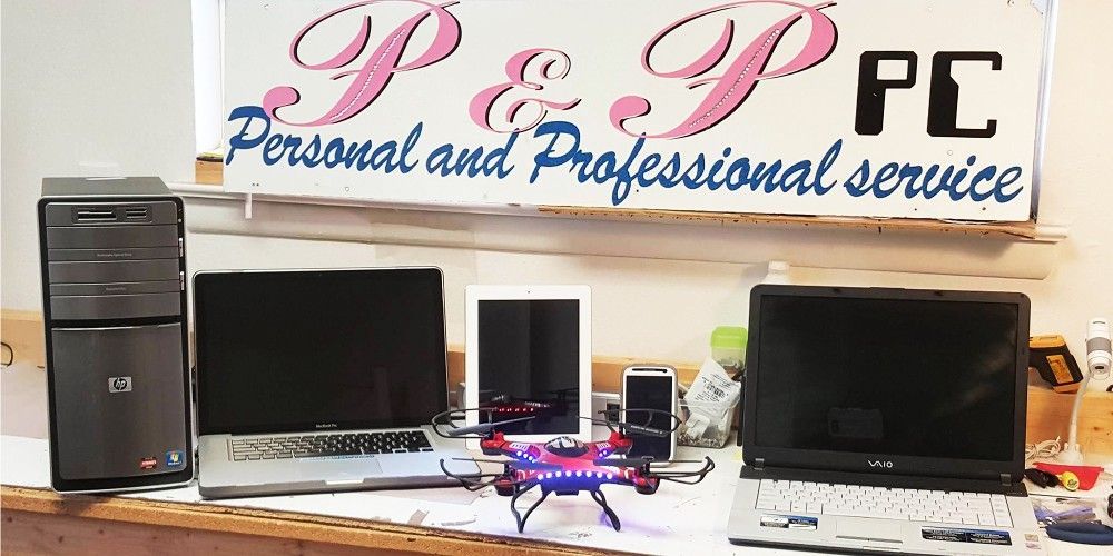 a bunch of laptops are sitting on a table in a room .
