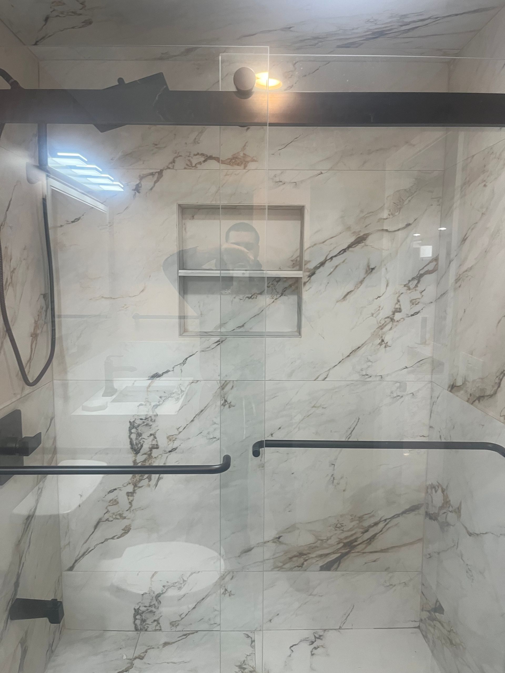 A white truck is parked in a parking lot next to a building.