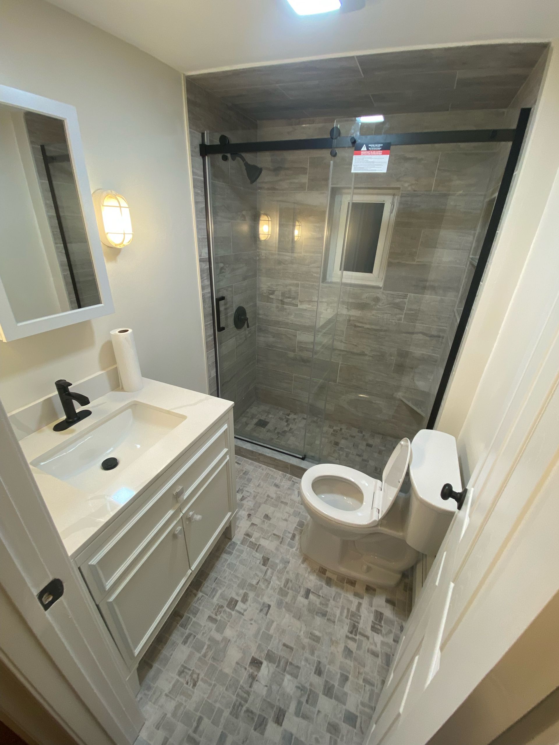 A white truck is parked in a parking lot next to a building.