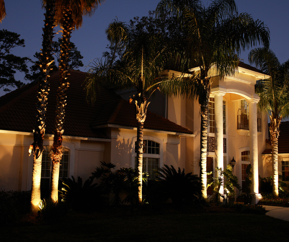 A wooden deck with stairs and a light on the railing at night.