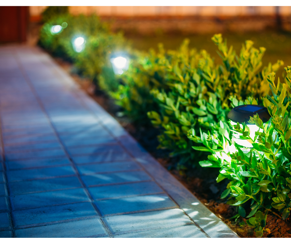 A wooden deck with stairs and a light on the railing at night.