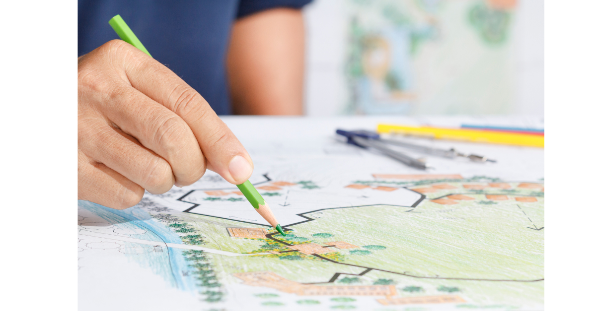 A person is drawing a project plan with a green pencil.