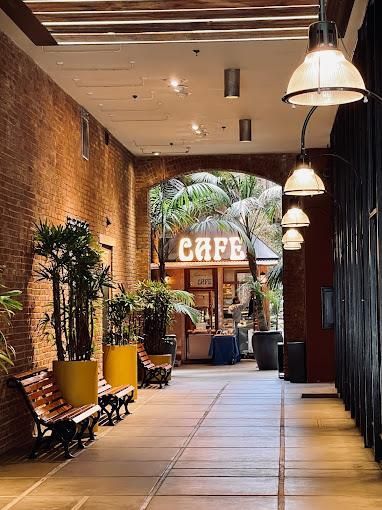 A large building with a brick wall and a sign that says ' krauss ' on it