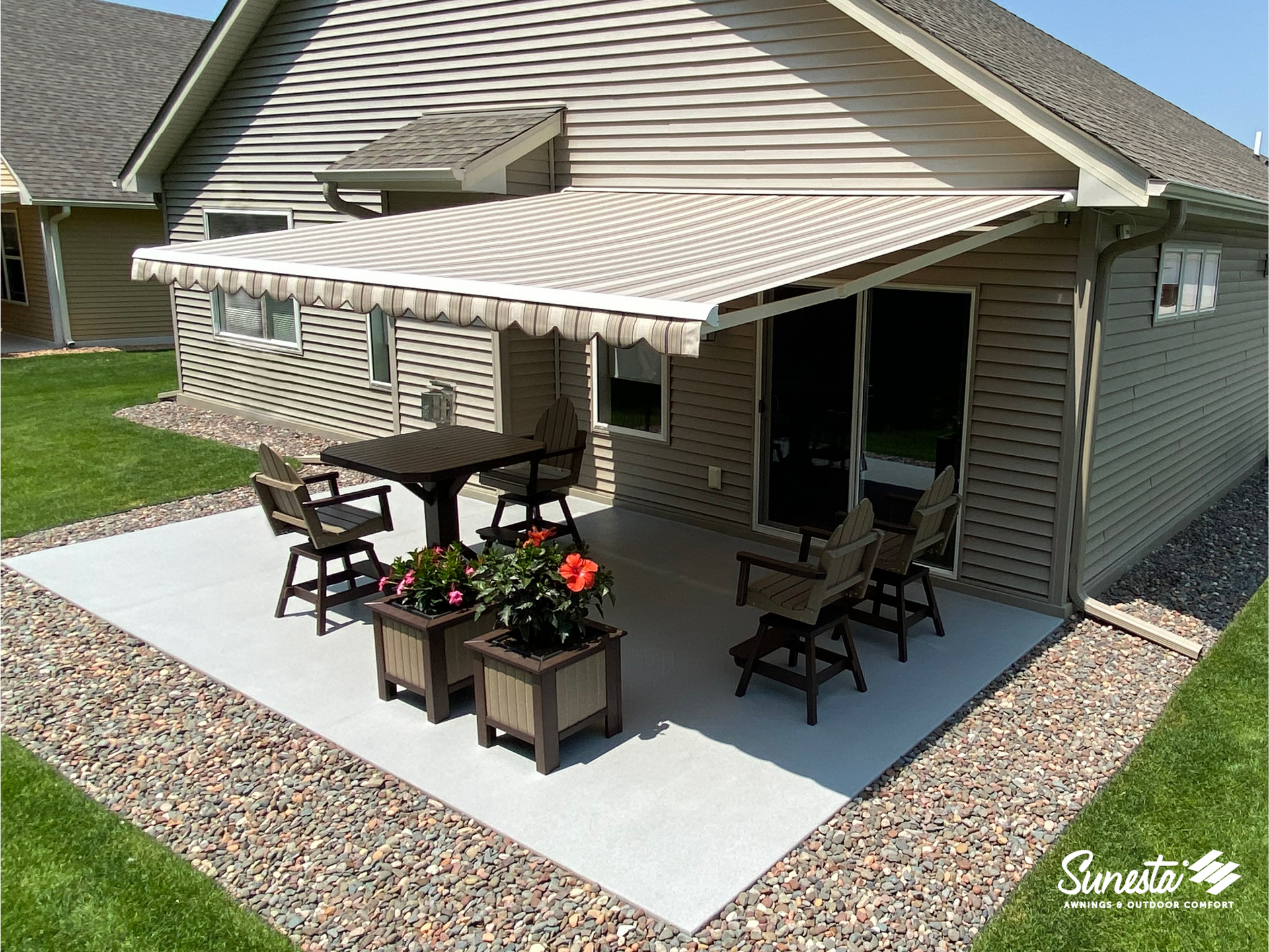 Red and white striped retractable awning with a blue sky and clouds in the background at The Blind Guy - Coeur d'Alene near Coeur d'Alene, ID