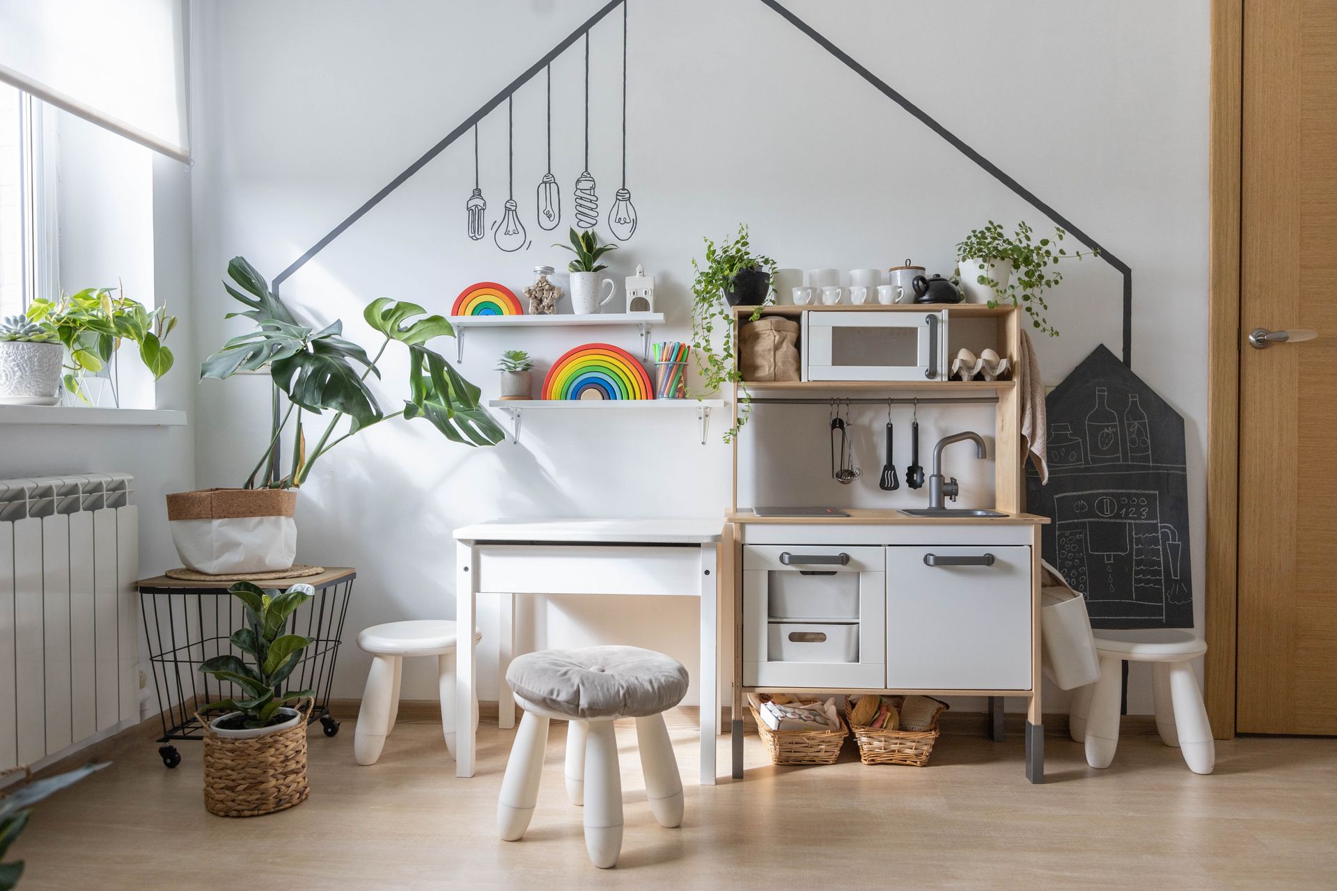 Child's playroom with cordless shades at the window and a play kitchen at the room's center 