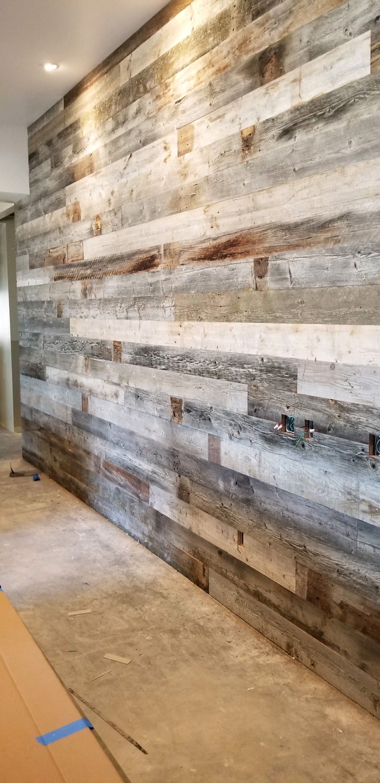 A wooden wall is being built in a hallway.