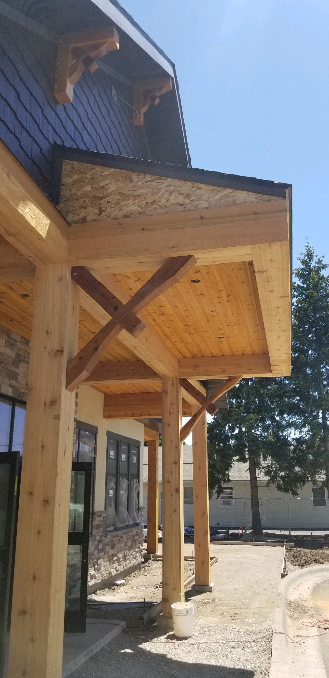 A wooden porch is being built on the side of a building.