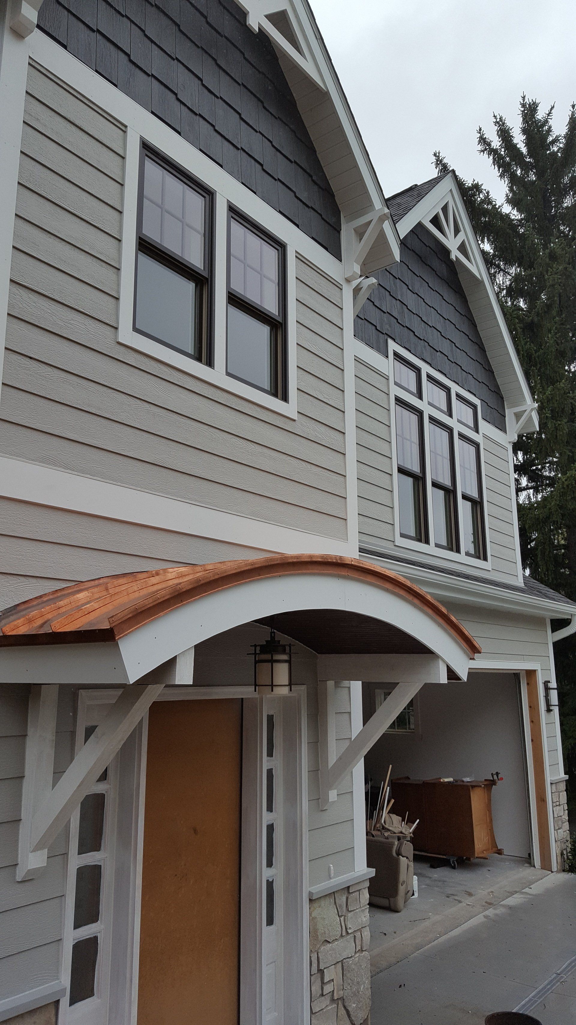 The front of a house with a canopy over the door.