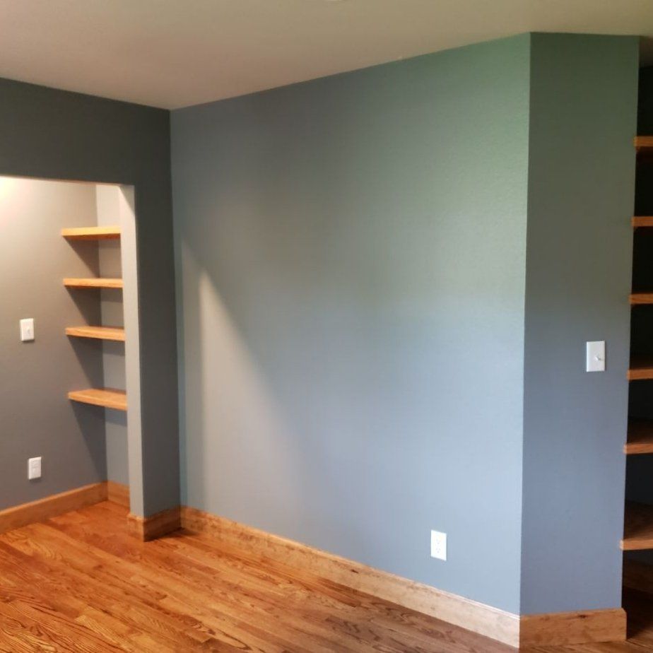 A room with a wooden floor and gray walls