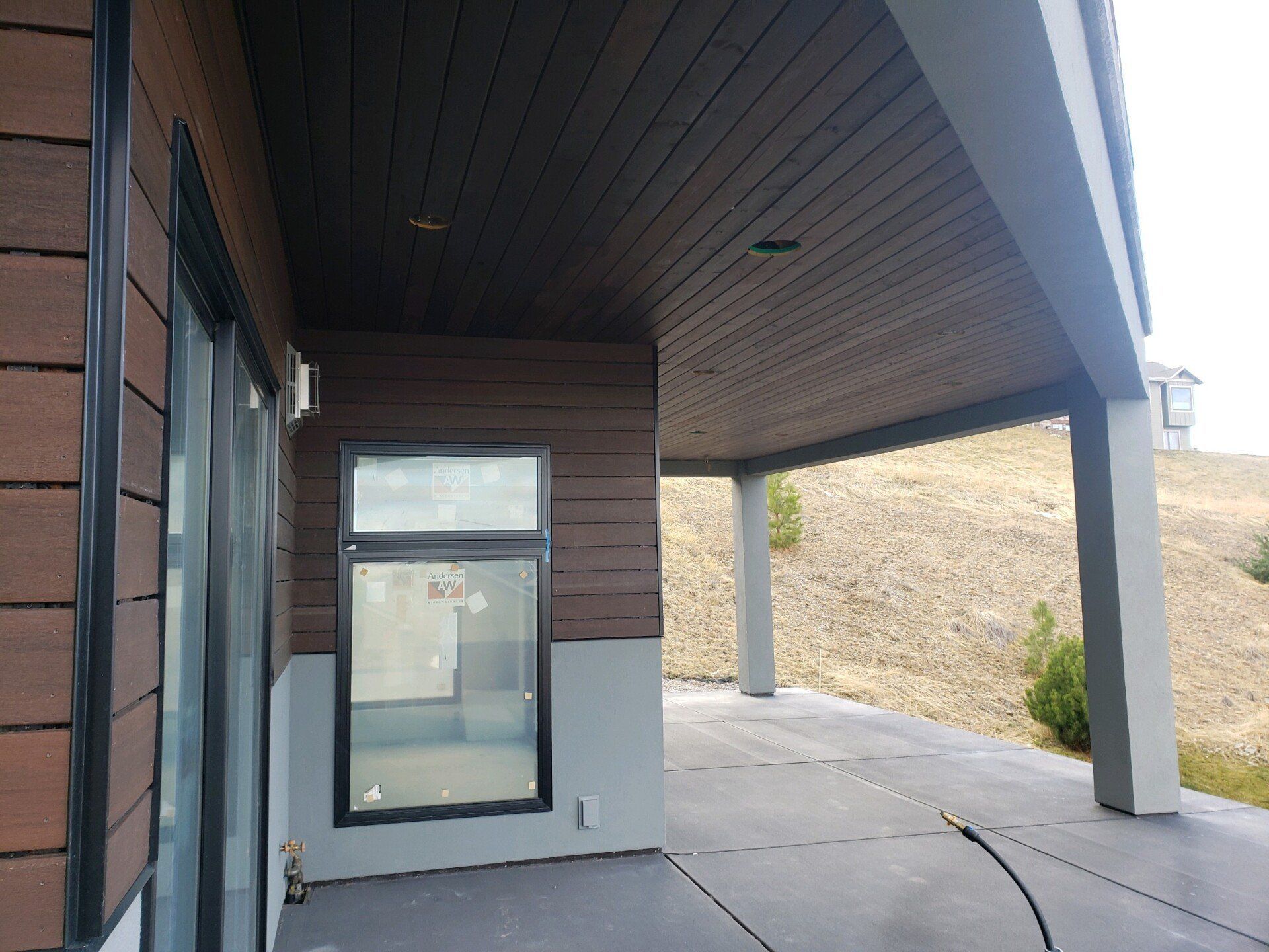 A house with a covered porch and a large window.