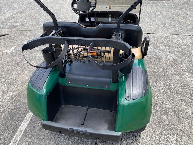 A Green Golf Cart Is Parked In A Parking Lot — Lift It Equipment in Summerland Point, NSW