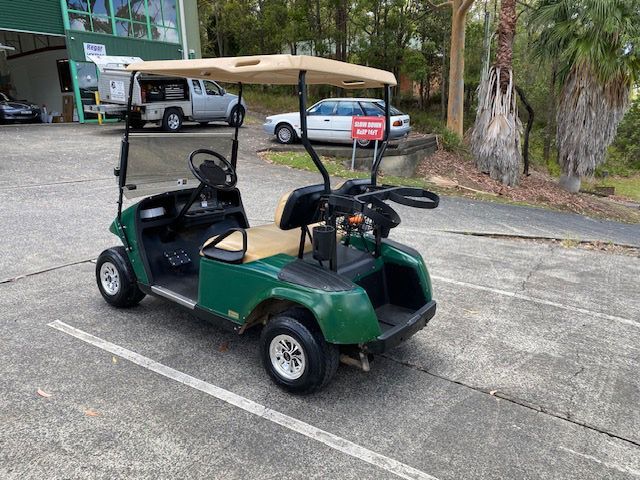 A Green Golf Cart Is Parked In A Parking Lot — Lift It Equipment in Summerland Point, NSW