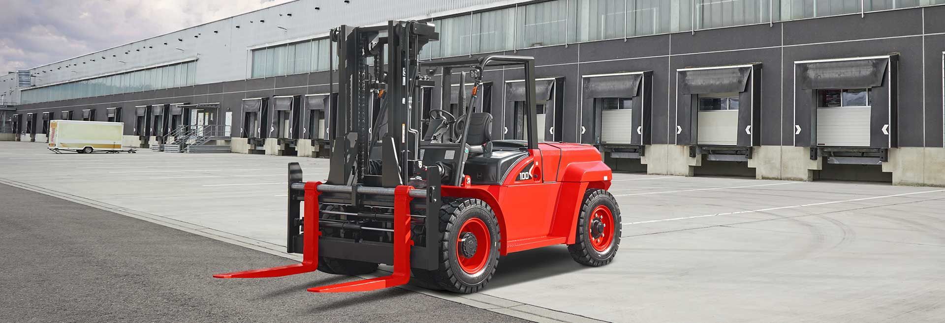 A Red Forklift Is Parked In Front Of A Warehouse — Lift It Equipment in Summerland Point, NSW